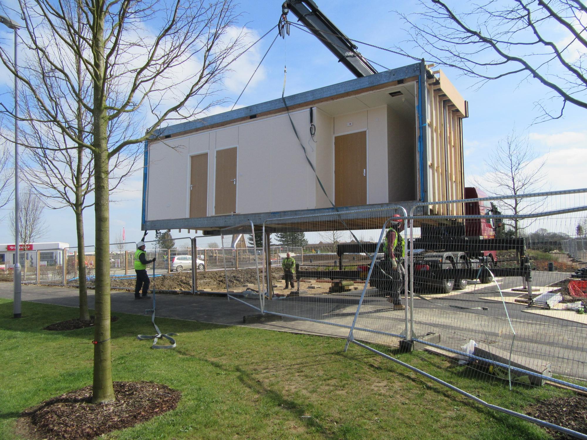 Modular community shop being craned in